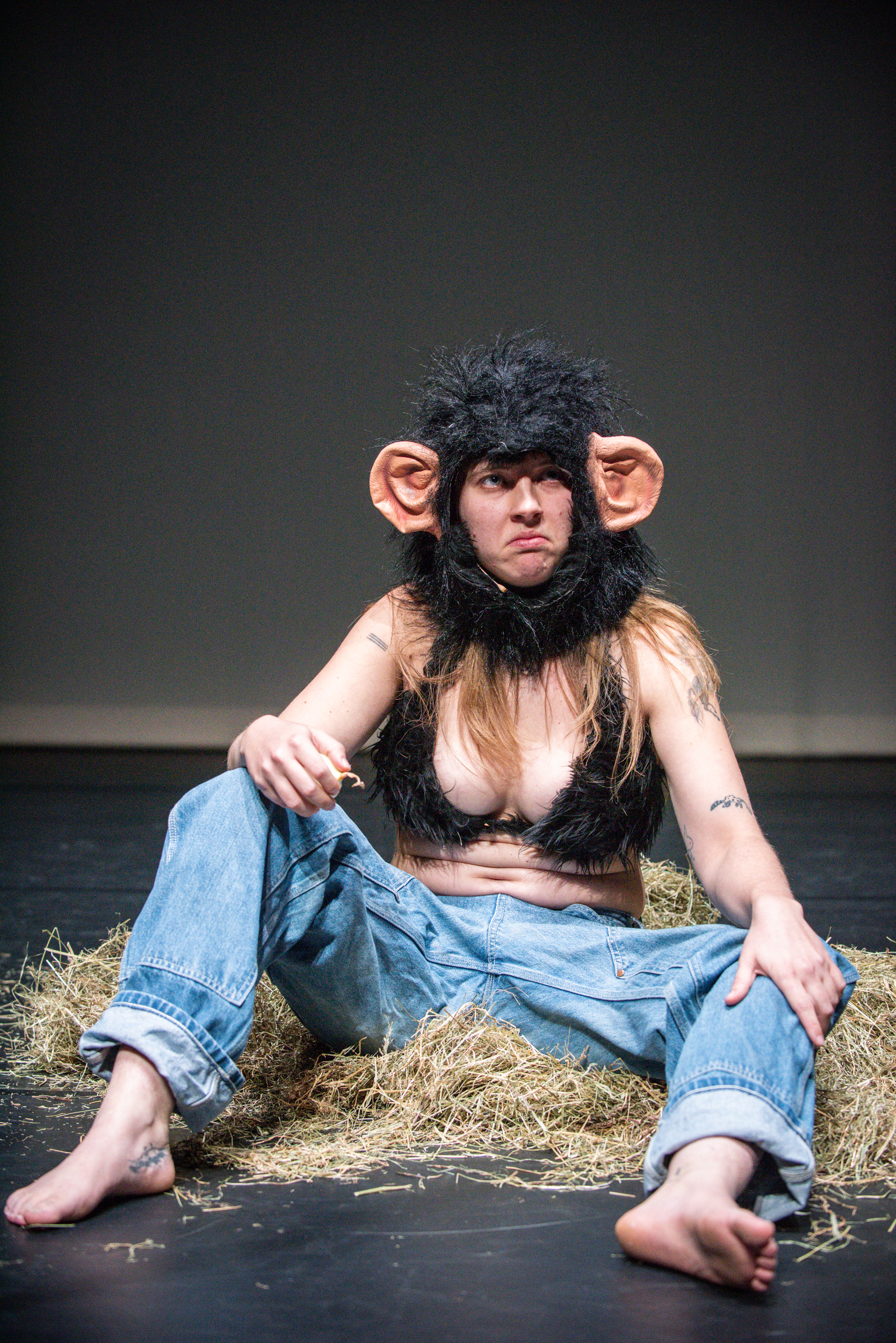 Performance eating an onion in a fur bikini