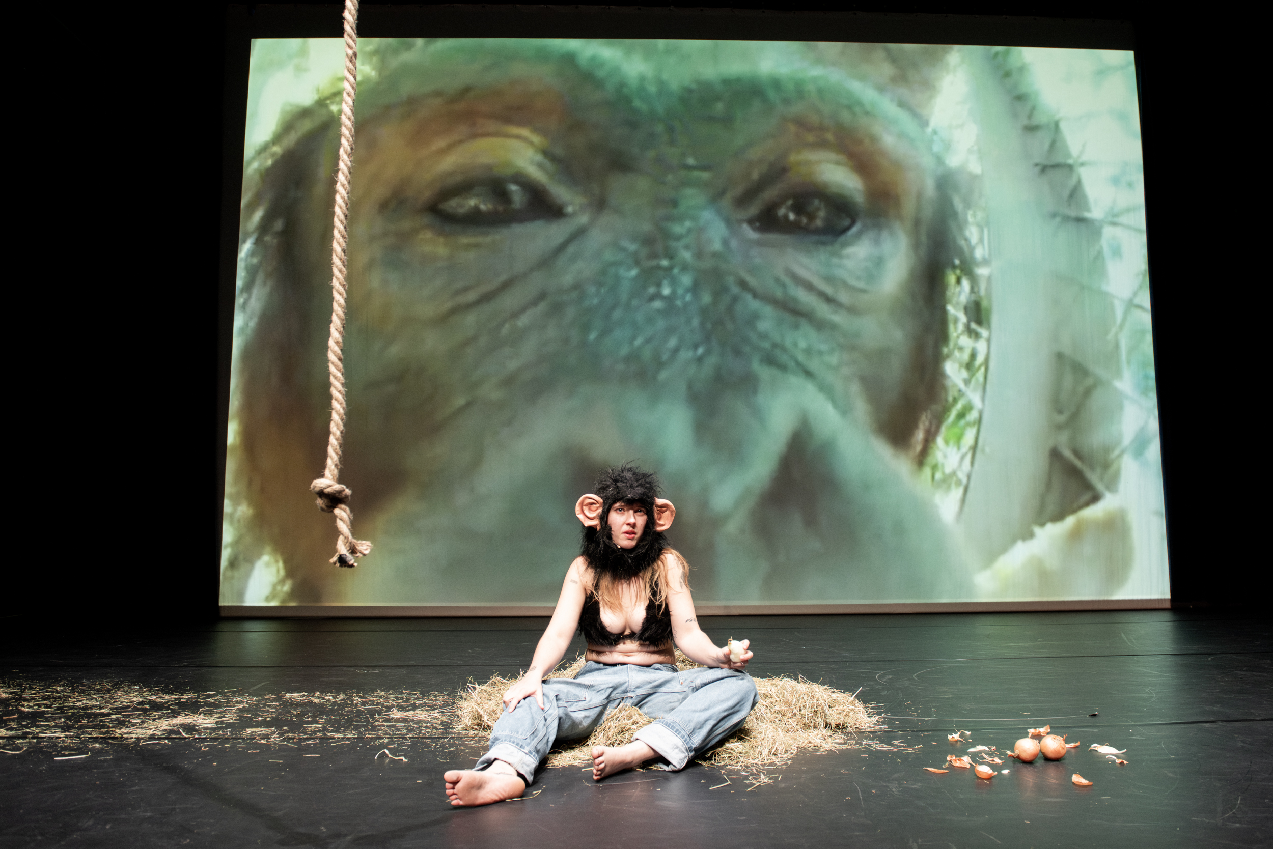 Performance eating an onion in a fur bikini