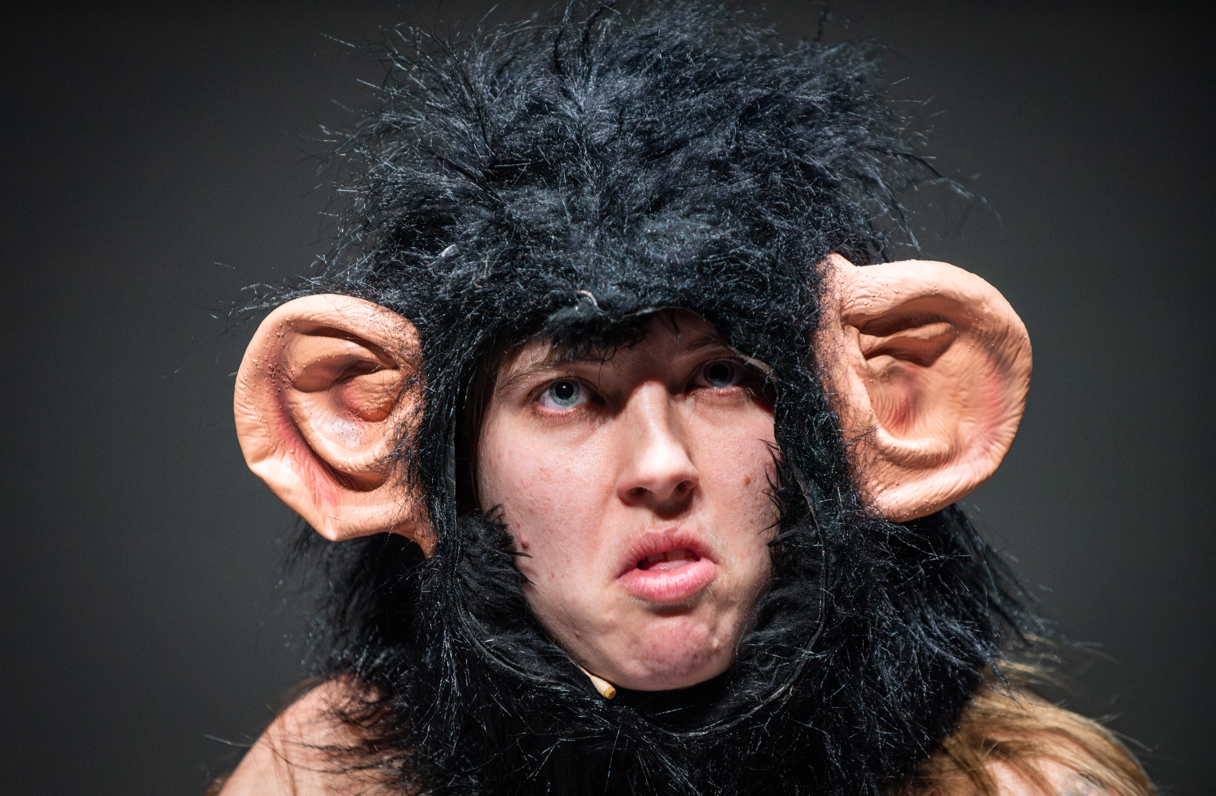 Performance eating an onion in a fur bikini