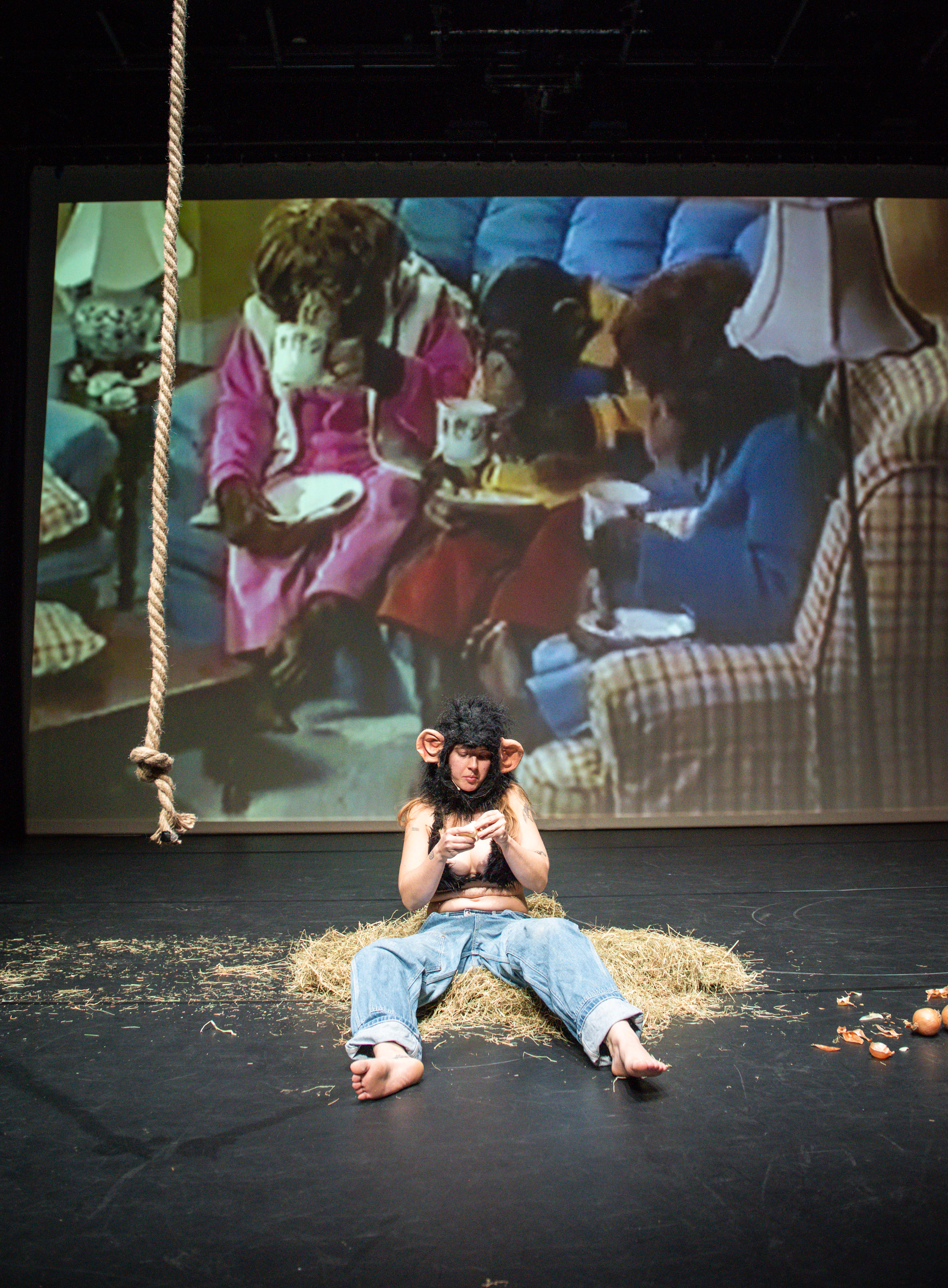 Performance eating an onion in a fur bikini