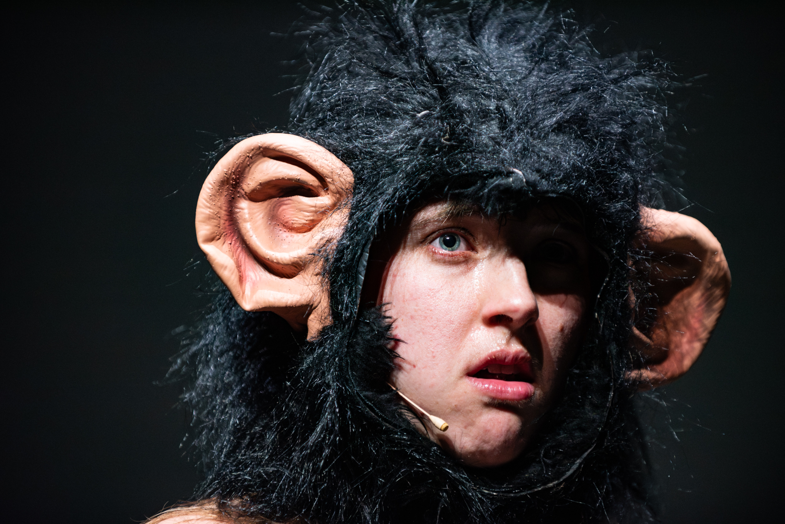 Performance eating an onion in a fur bikini